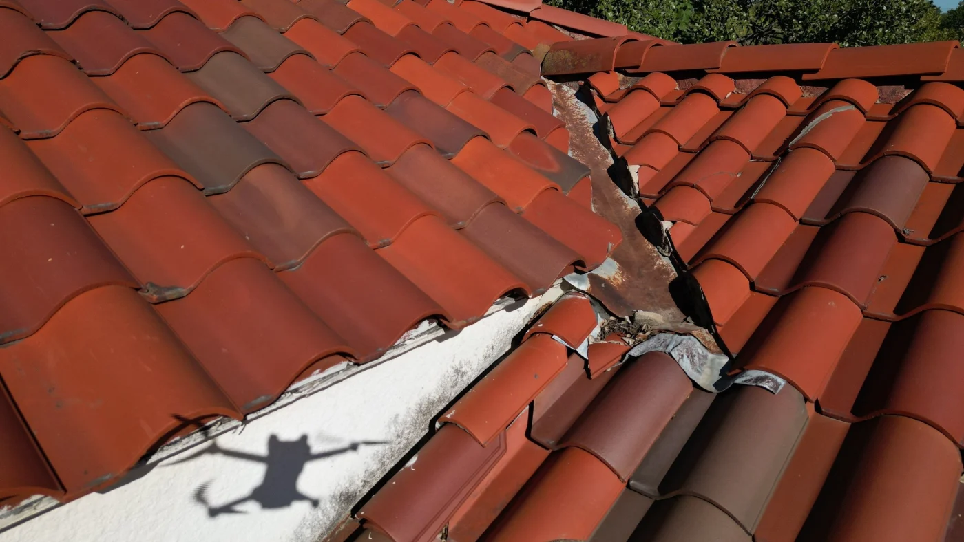 Drone view of damaged tile roofing
