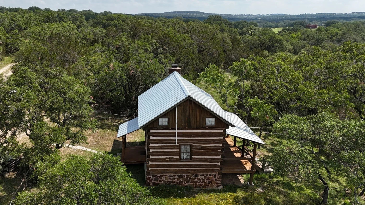 A historic cabin with a metal roof