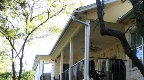 A front porch with a gutter system