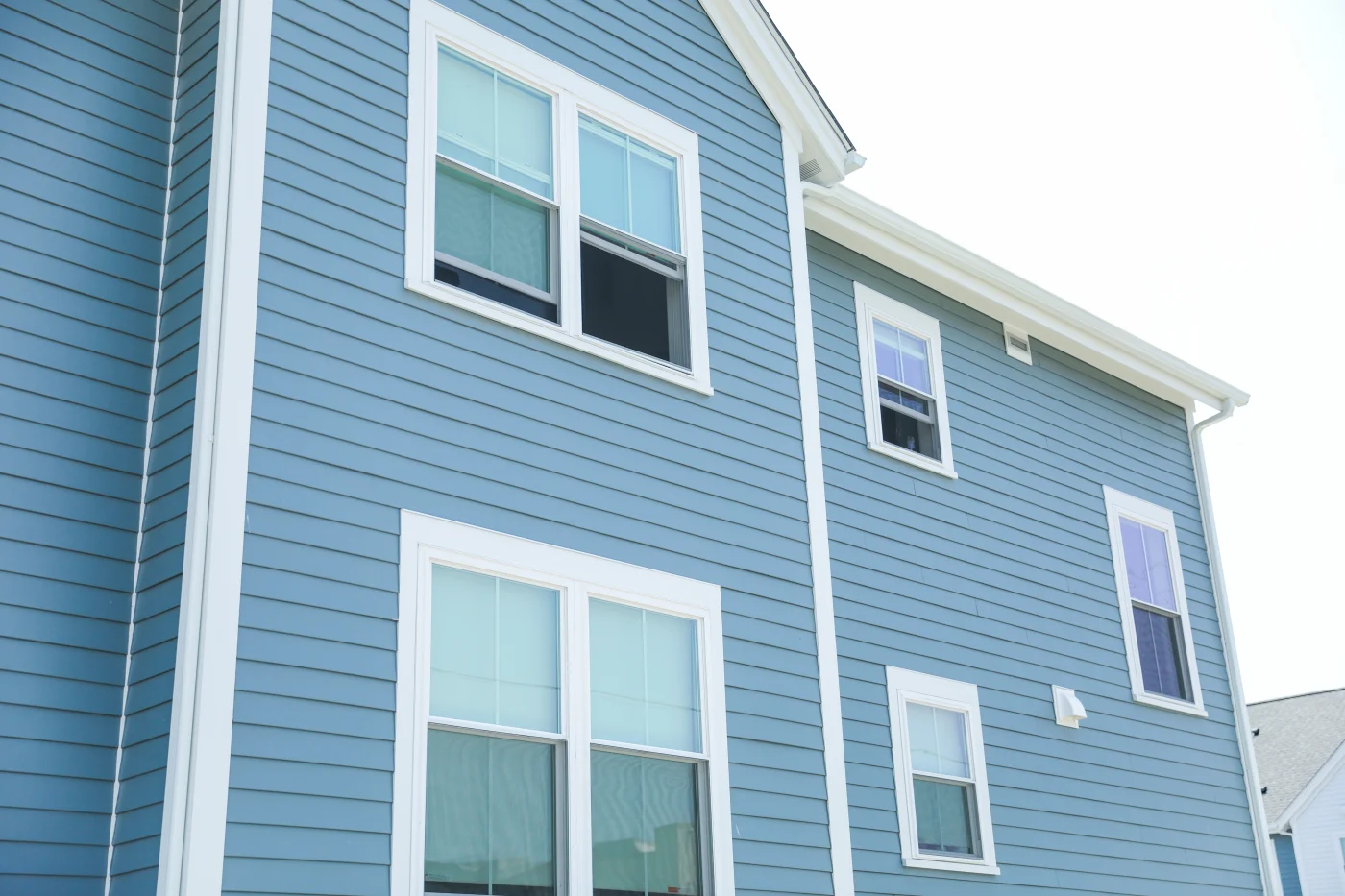 Beautiful Siding Installation In San Antonio, TX | Lynx Roofing New beautiful blue vinyl siding with white trim.